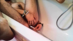 Bi-guy using shower head, squirting water, enema
